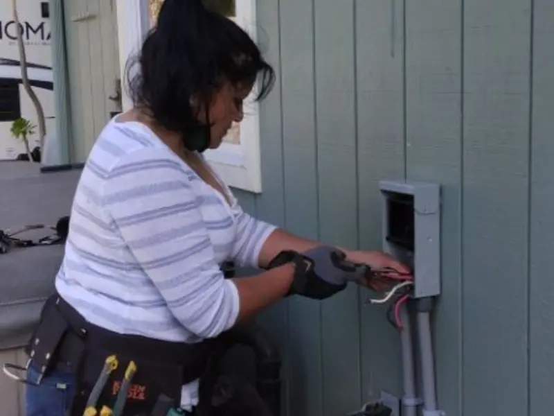 Licensed electrician wiring an exterior subpanel in Pelham